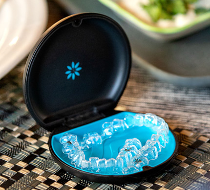 Invisalign aligner case open on a table