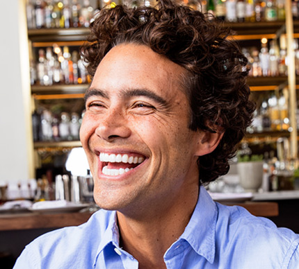 Man smiling confidently indoors