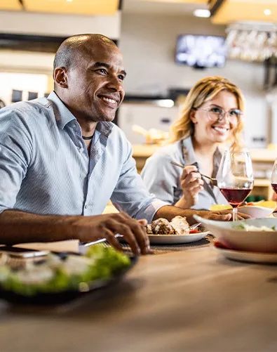 Man is eating dinner with friends
