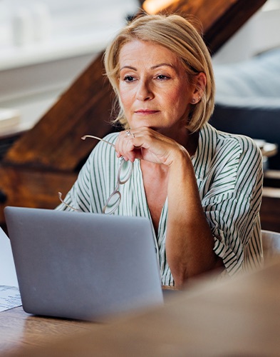 Woman reads on laptop