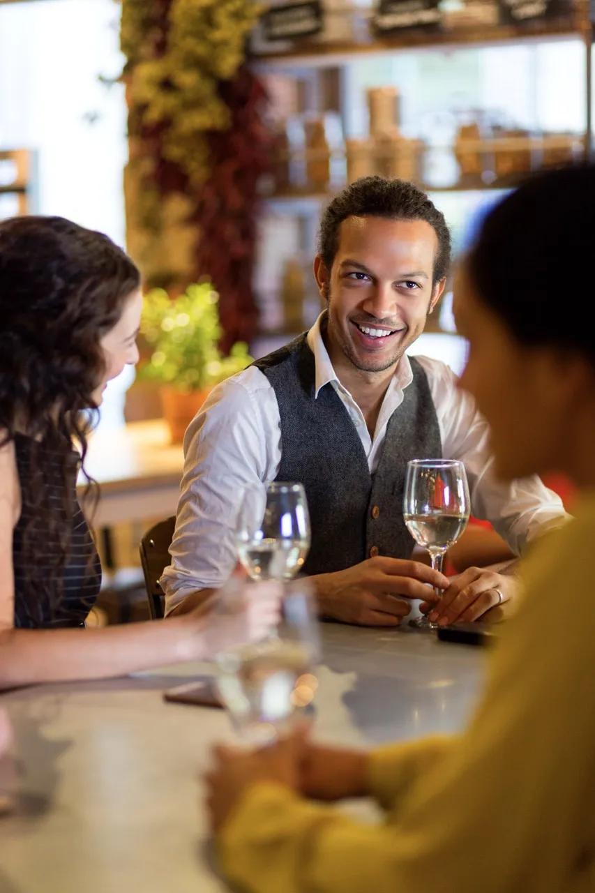 Man is eating dinner with friends