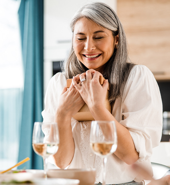 Woman holds a gift and she is happy