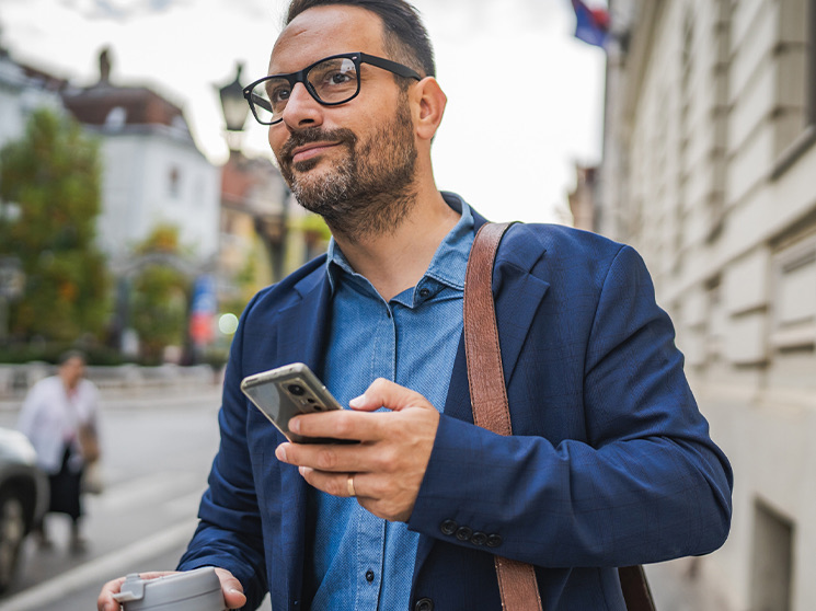 Man holds a phone and looks away