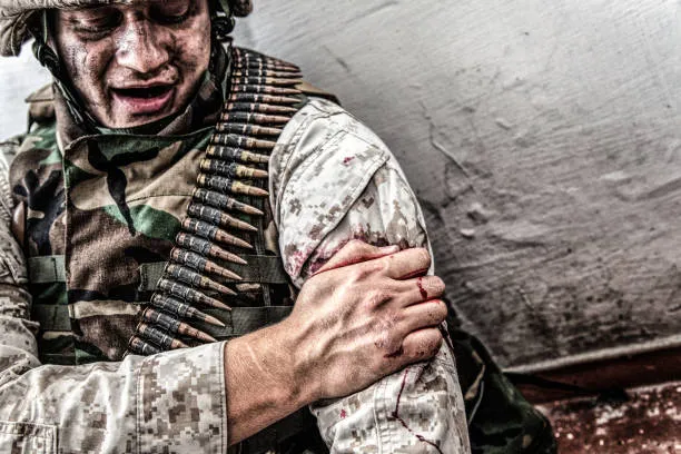 Wounded soldier holding his arm