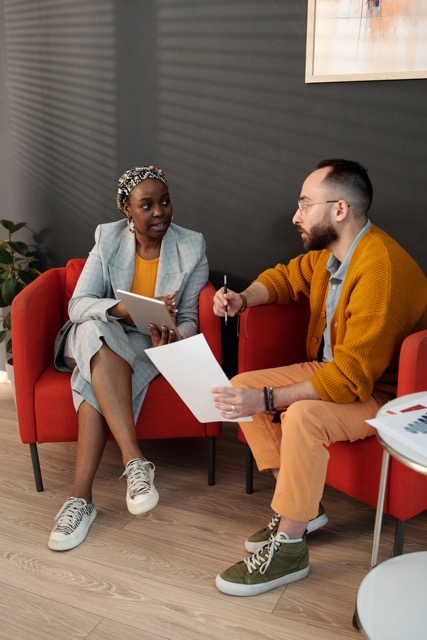 Conversation between a woman and a man at work
