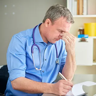 A photo of a thoughtful doctor