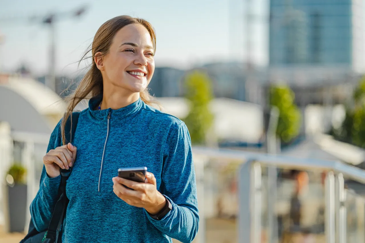 A picture of smiling woman with a phone