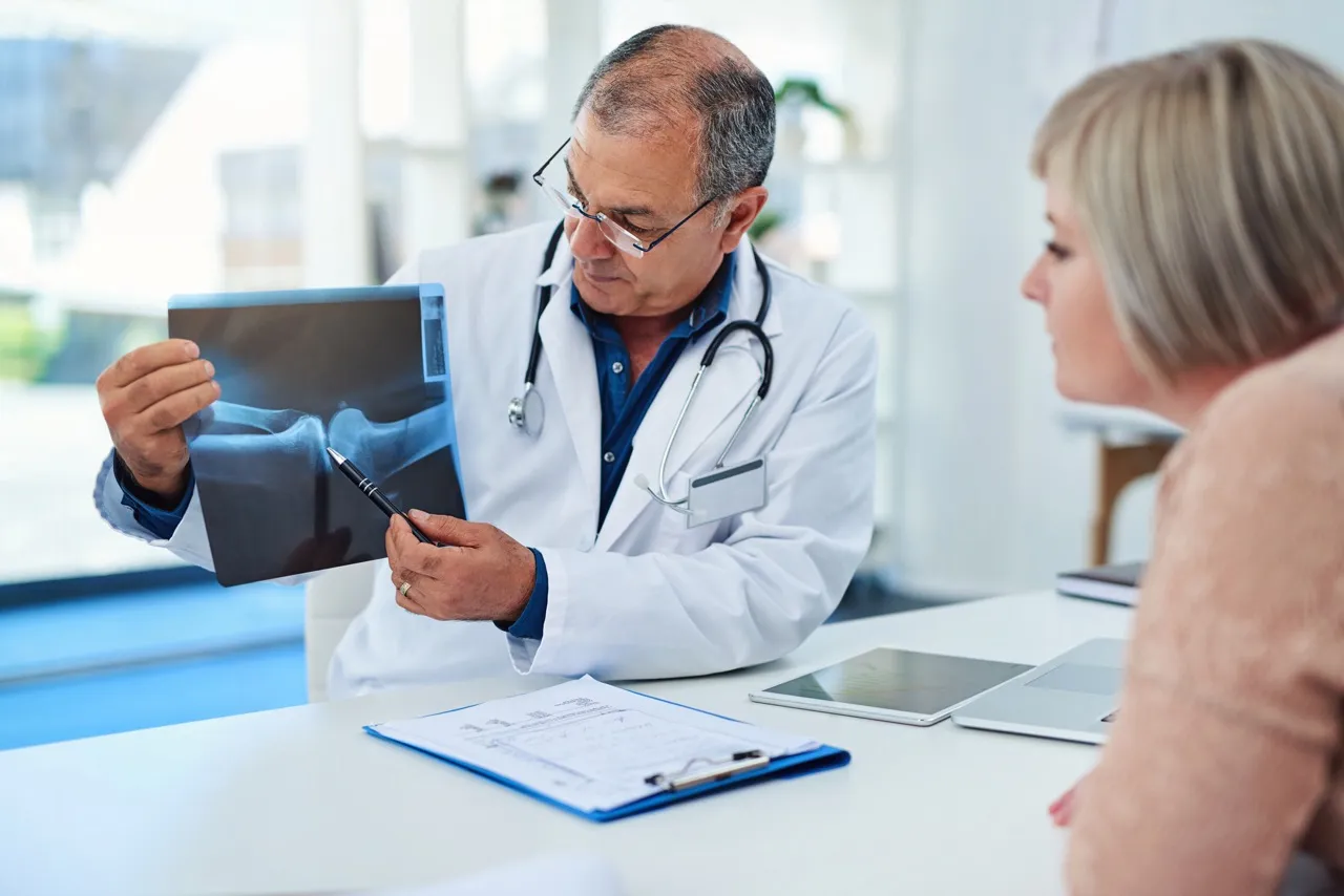 The doctor consults the patient and shows the x-ray picture