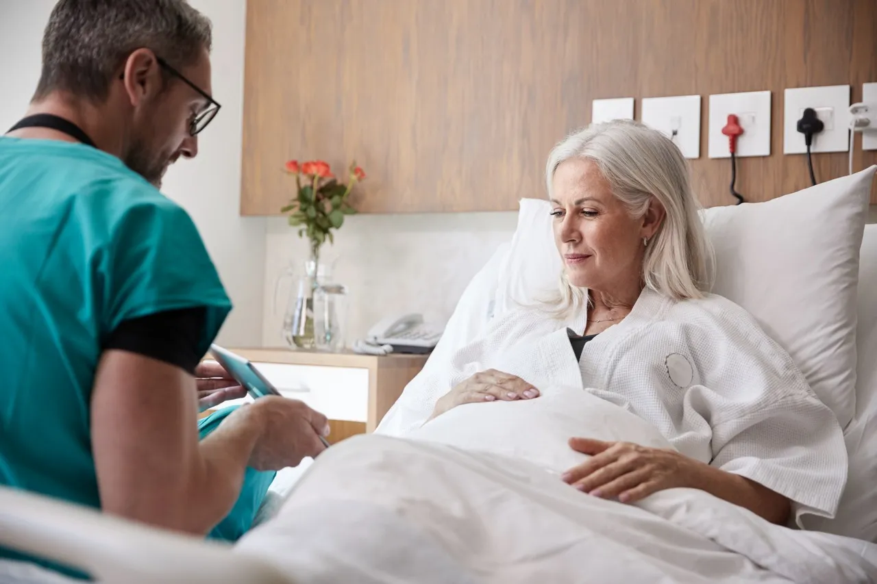 Doctor visiting a patient in a hospital bed