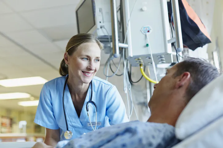Doctor and lying patient under respirator
