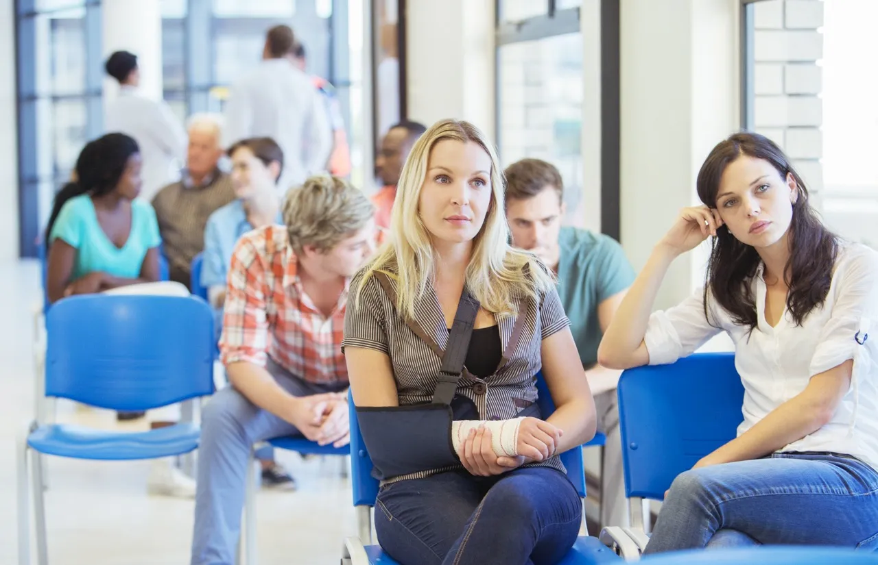 Woman with broken arm waits in hospital waiting room