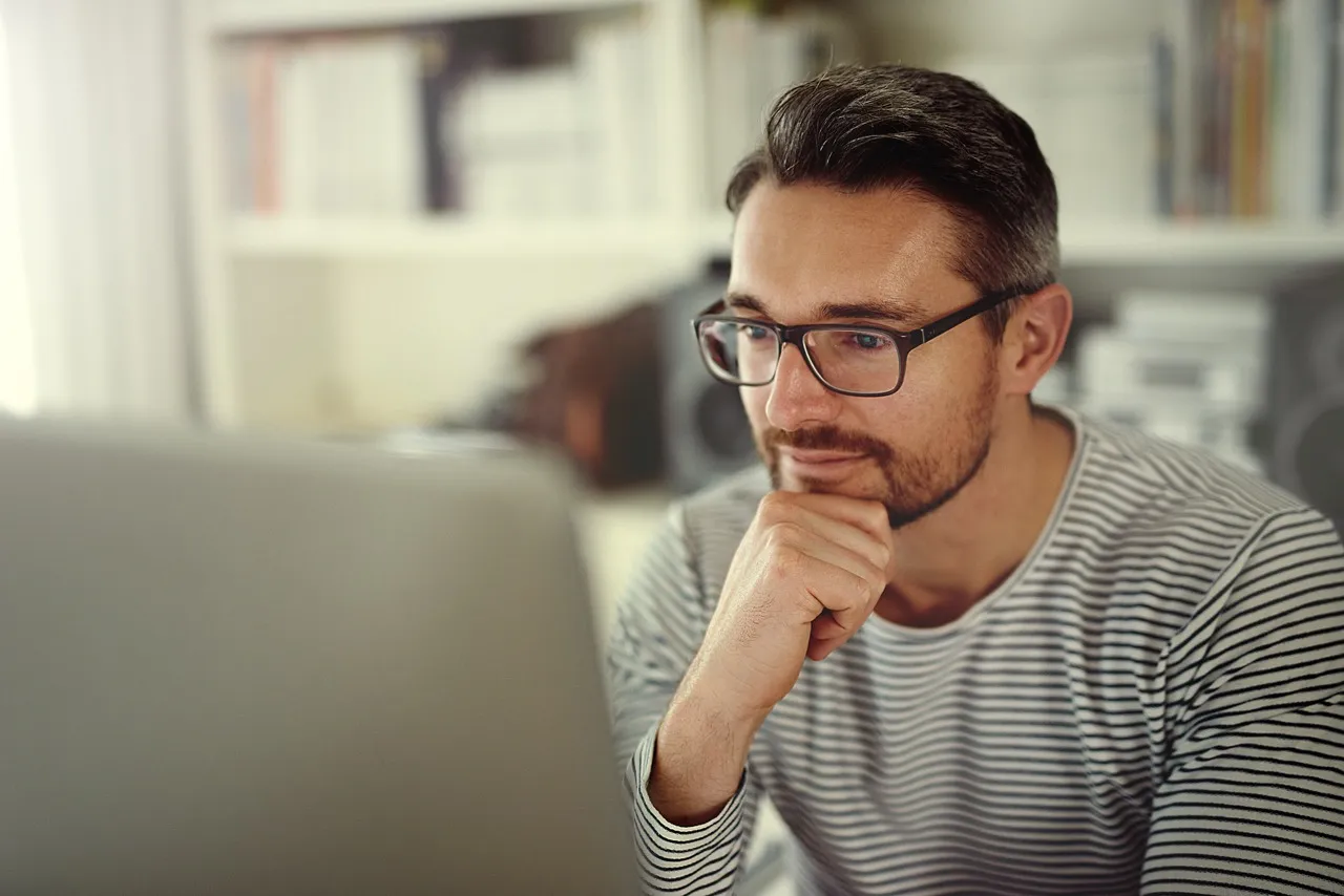 Man reading on laptop