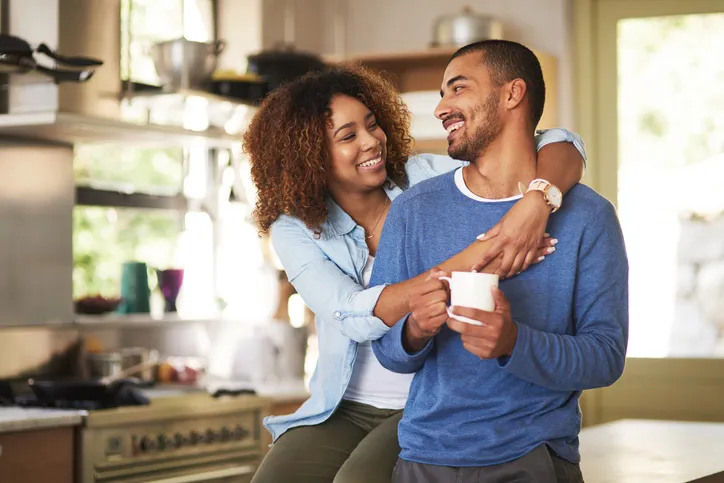 Couple of people smile and hug together