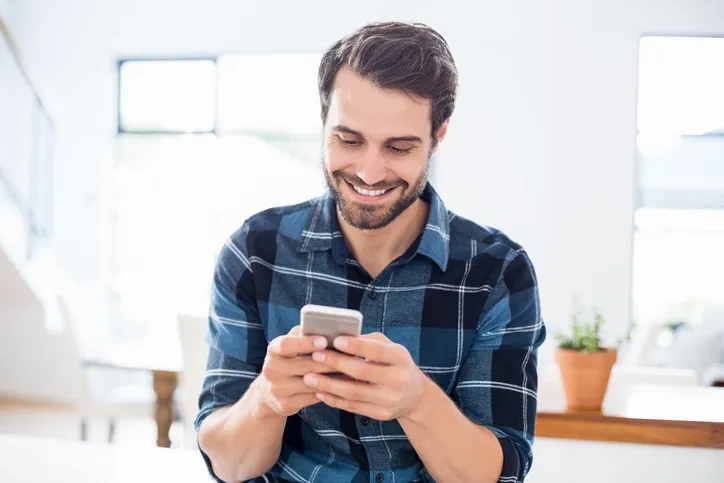 Man smiles and talks on the phone