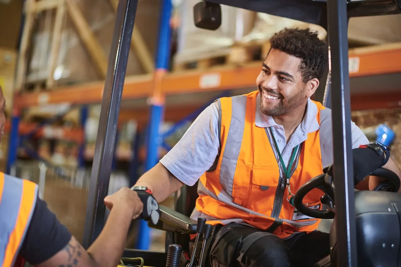 A man working on a forklift