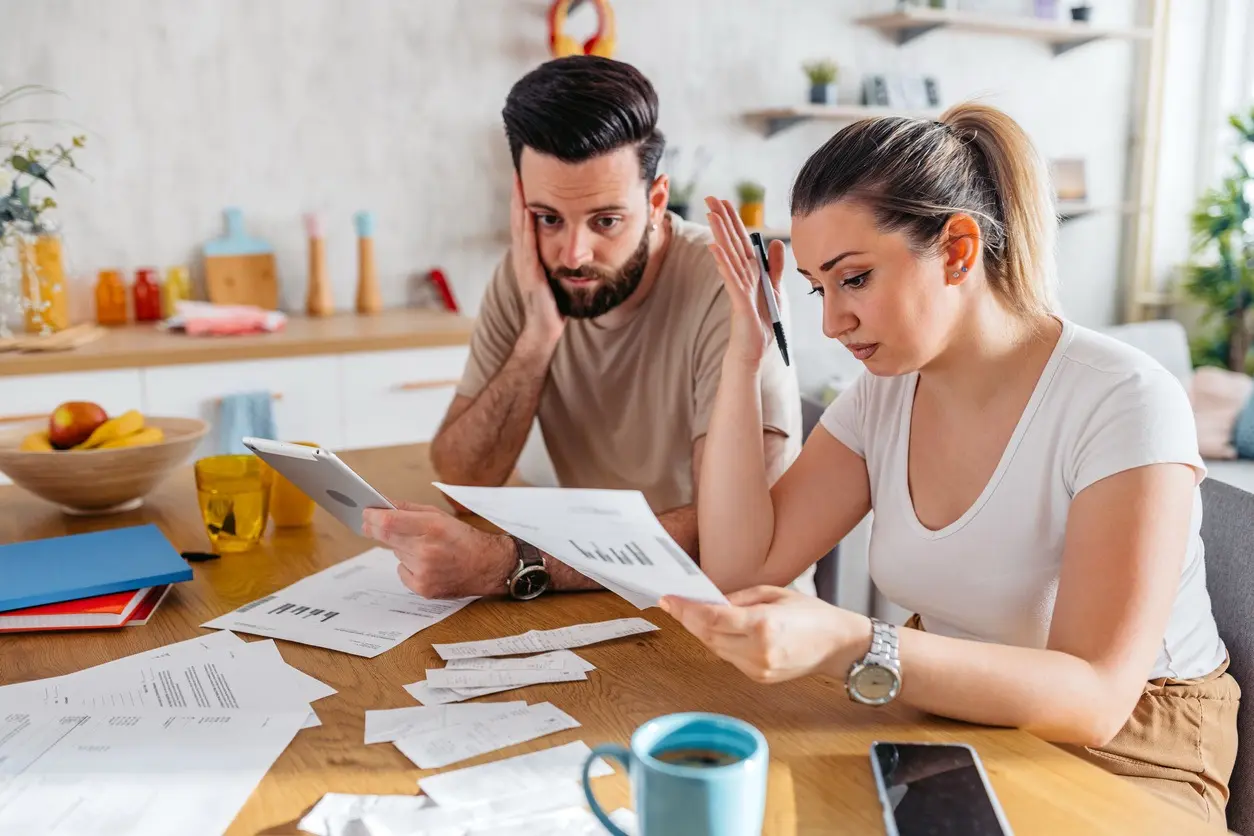 The couple is going over their bills and looking for a solution